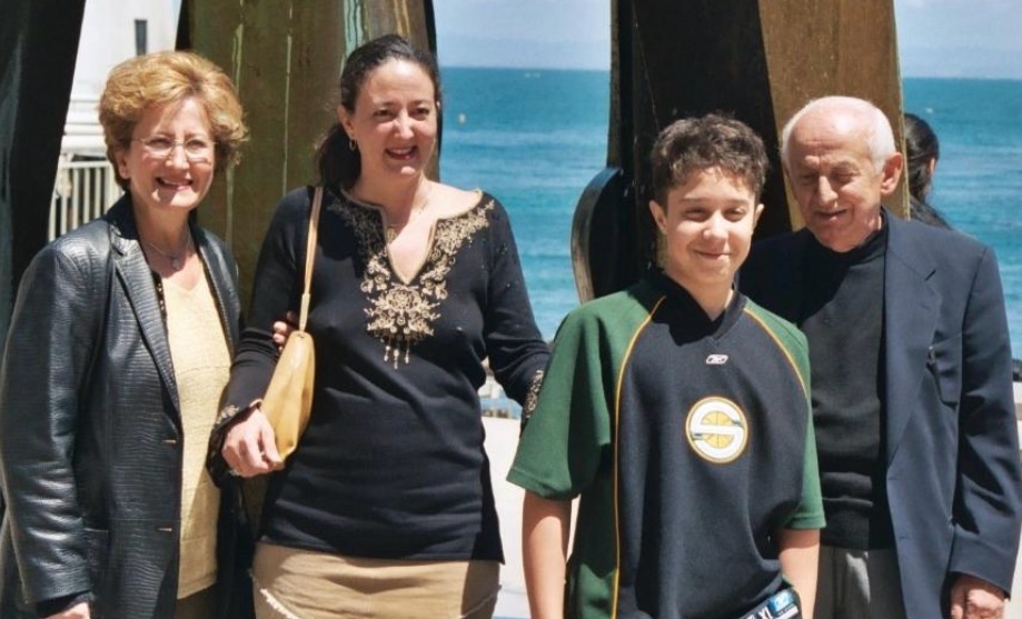 Four members of the Serpanos family smiling together by the water
